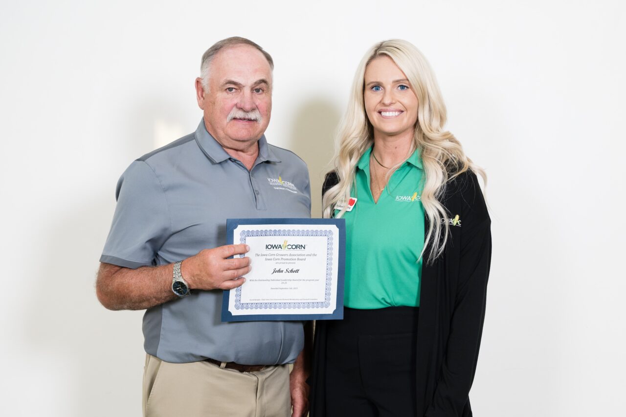 John Schott poses with Iowa Corn Local Leader Award certificate, alongside Iowa corn District Field Manager Shelton Hatch Hoefling
