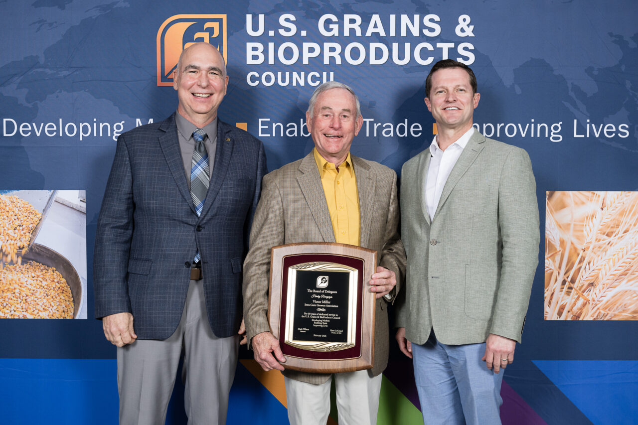 Vic Miller is recognized with a plaque for 30 years of service to the U.S. Grains & BioProducts Council.